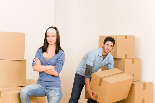 Boxes and household items being unloaded at a new Mortlake home